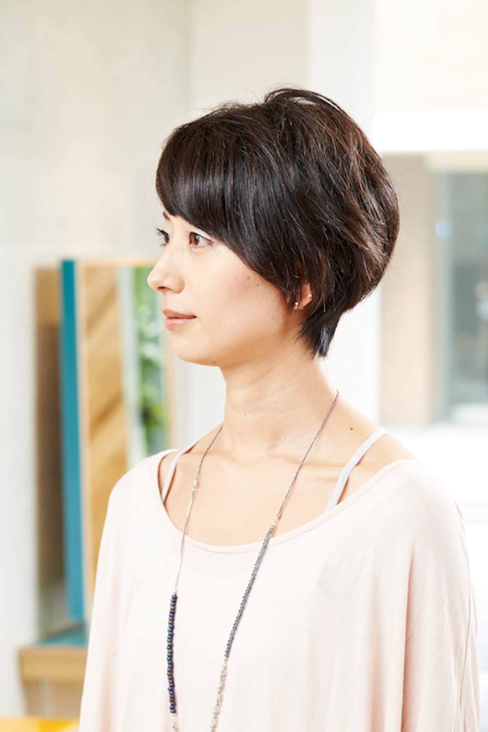 横顔の黒髪ショートヘアの女性