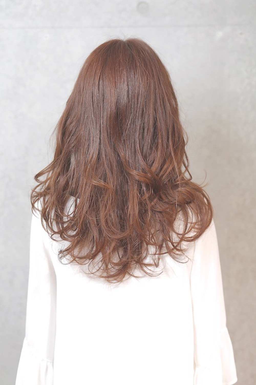 ハイトーンロングヘアの女性（バック）