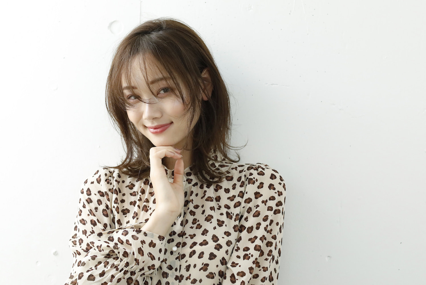 寝起きのようなヘアスタイルの女性（右手を顎の下置いてる）